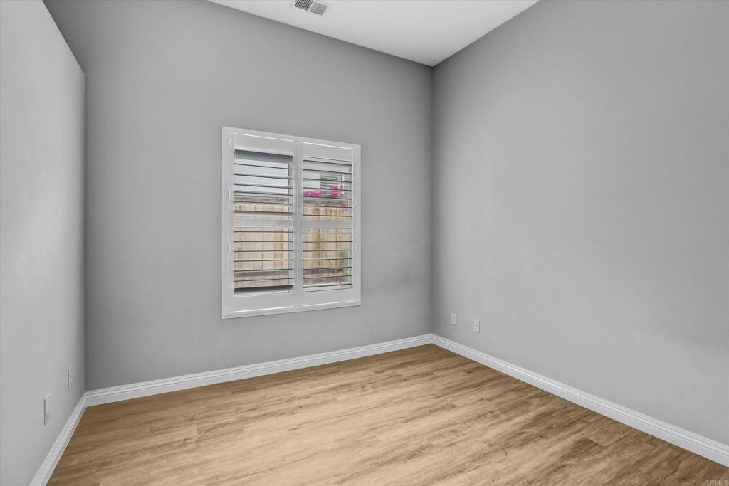 2318 Fallbrook Place Escondido, CA 92027 - Photo 20 of 34 wooden floor in an empty room with a window