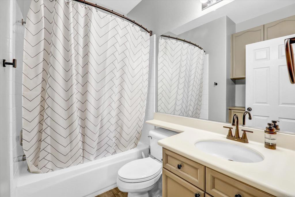 2318 Fallbrook Place Escondido, CA 92027 - Photo 22 of 34 a bathroom with a sink a toilet and a shower curtain