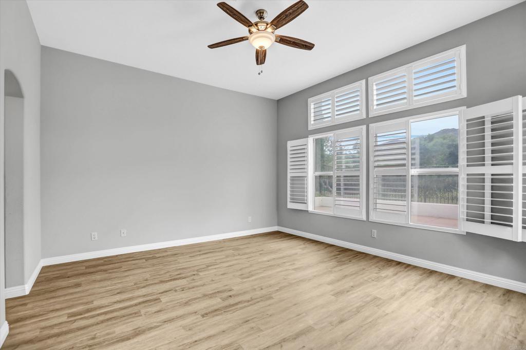 2318 Fallbrook Place Escondido, CA 92027 - Photo 23 of 34 a view of wooden floor and a chandelier fan in a room