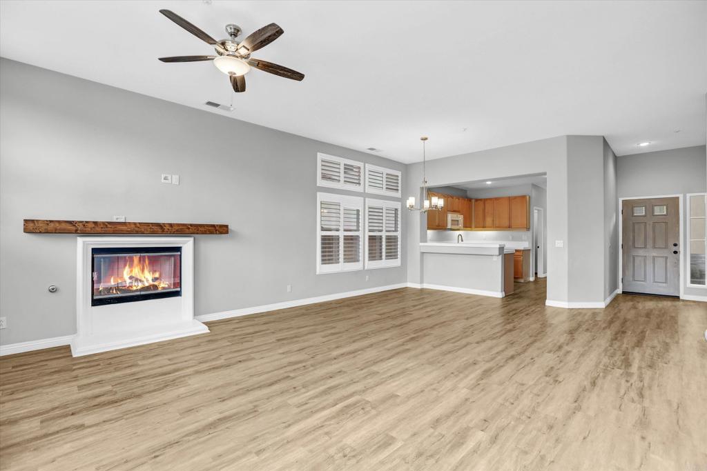 2318 Fallbrook Place Escondido, CA 92027 - Photo 5 of 34 a view of an empty room with a window and wooden floor