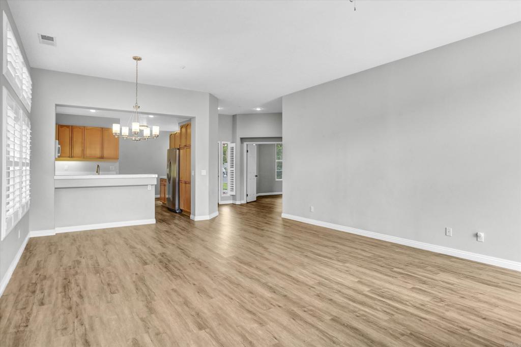 2318 Fallbrook Place Escondido, CA 92027 - Photo 8 of 34 an empty room with wooden floor and windows