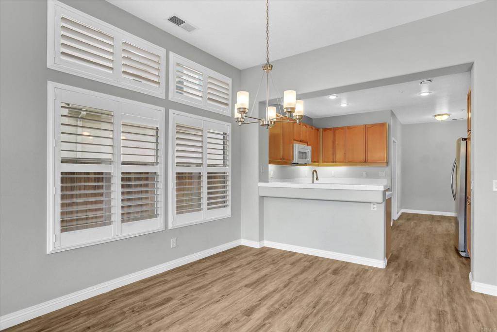 2318 Fallbrook Place Escondido, CA 92027 - Photo 9 of 34 a view of kitchen with granite countertop window and wooden floor