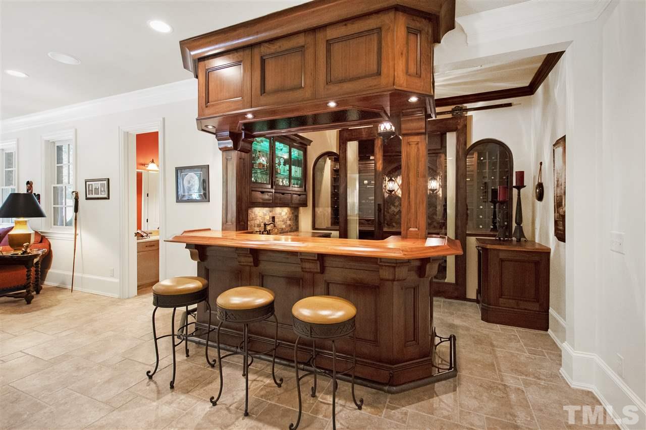 1512 Consett Court Raleigh, NC 27613 - Photo 19 of 30 Custom bar with tiger maple top and wine grotto with glass barn doors