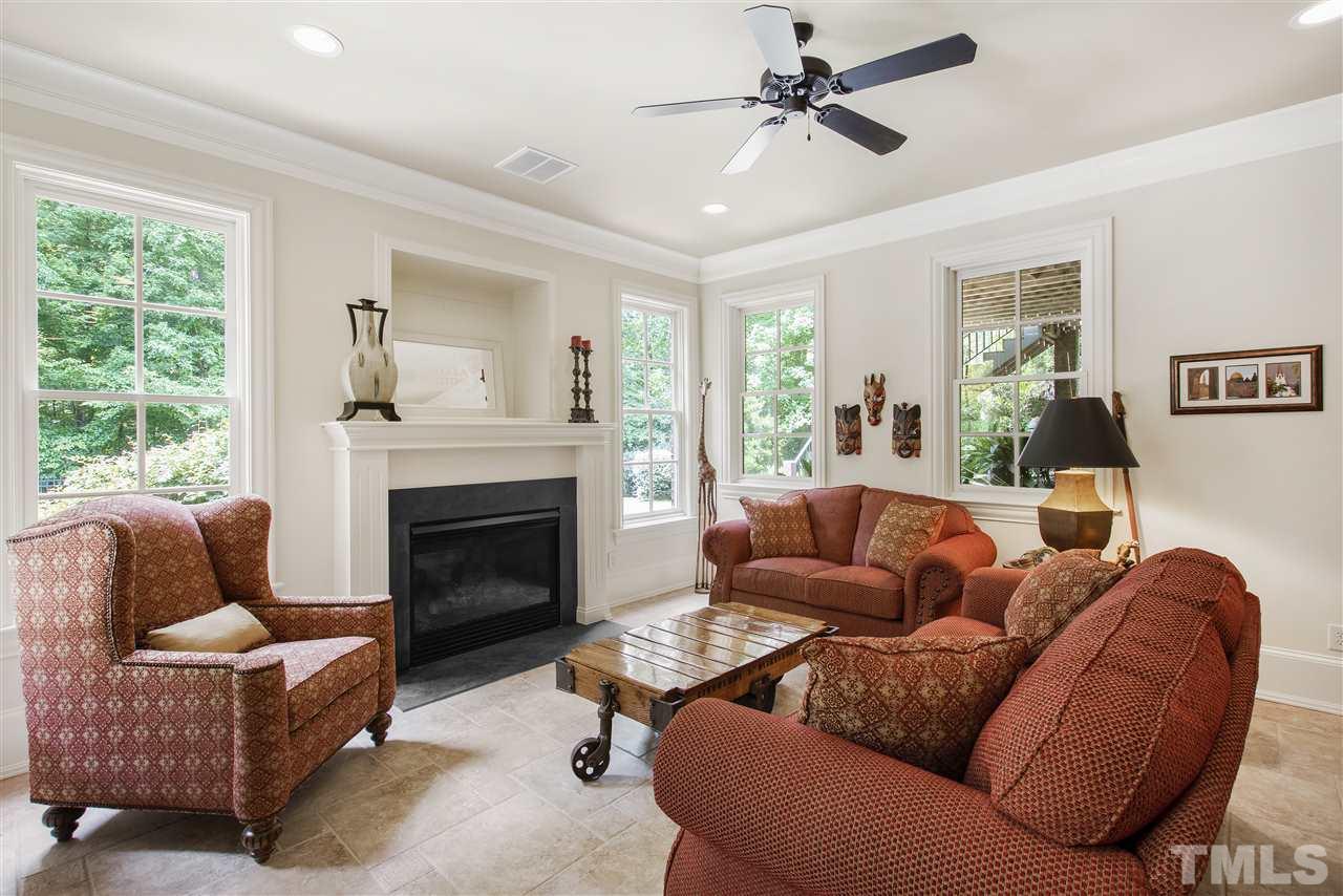 1512 Consett Court Raleigh, NC 27613 - Photo 24 of 30 Basement family room with gas log fireplace and French door to coverd patio with fire pit