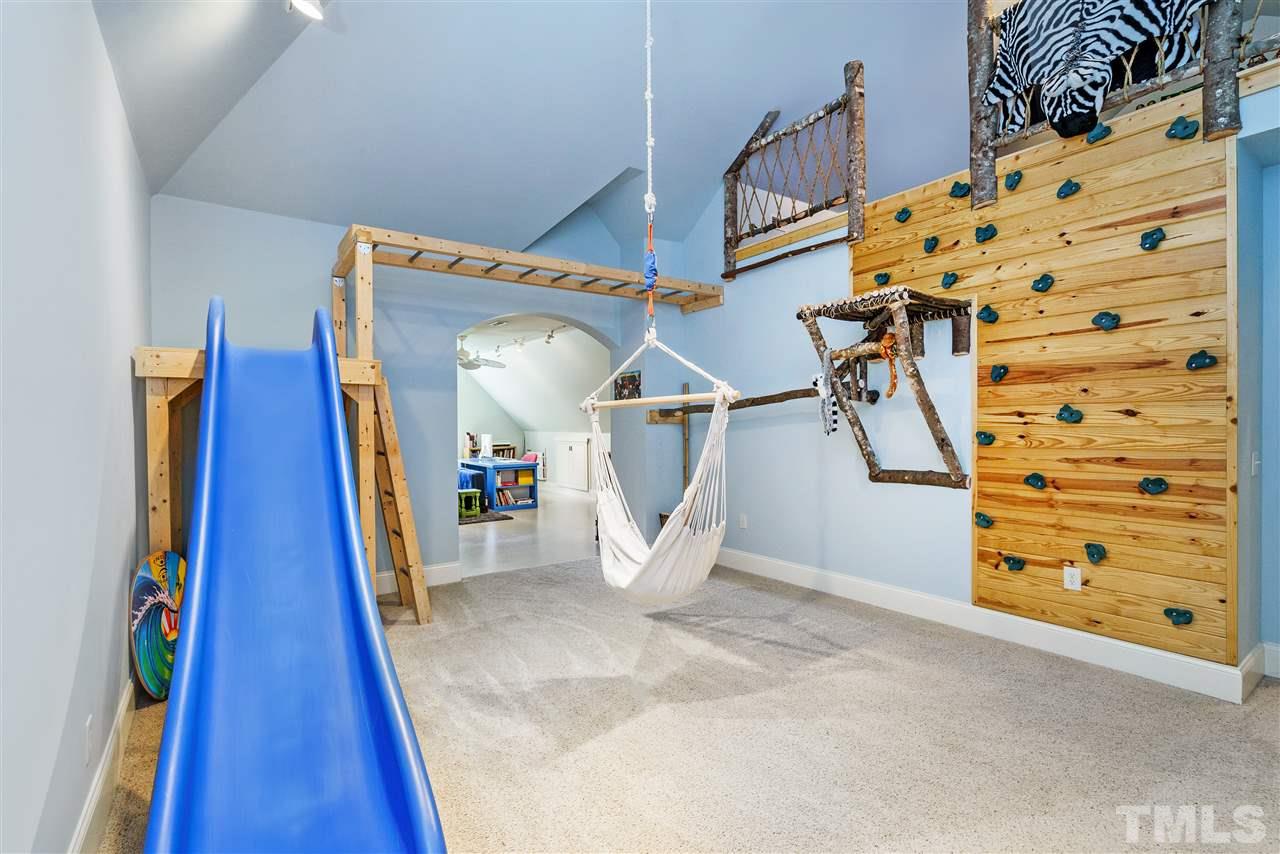 1512 Consett Court Raleigh, NC 27613 - Photo 26 of 30 Kid's playroom with climbing wall, loft, swing, and slide.