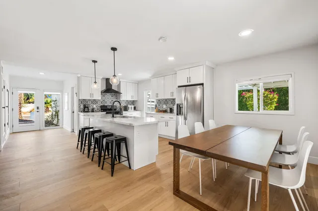 a dining room with furniture and a floor to ceiling window