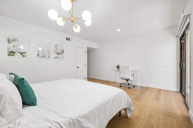 a bedroom with a bed and a table