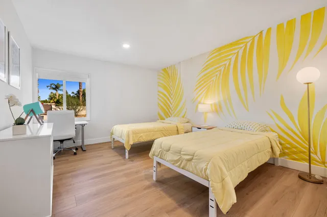 a backyard of a house with table and chairs