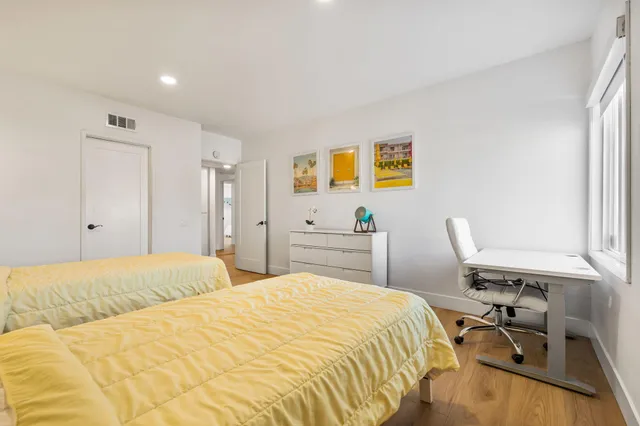 a view of a patio with table and chairs potted plants and palm tree