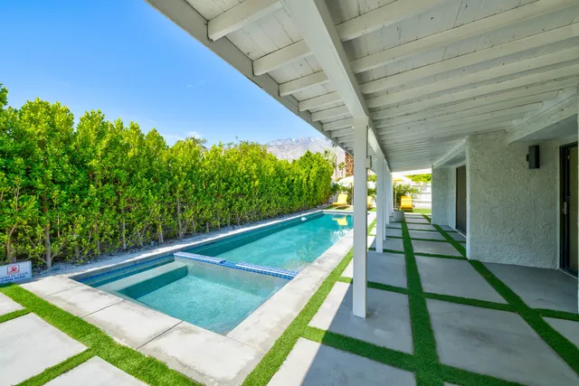 a view of a house with backyard sitting area and garden