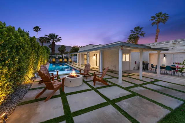 a view of swimming pool with a chairs