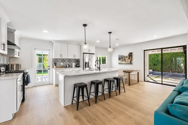 a large kitchen with a table and chairs