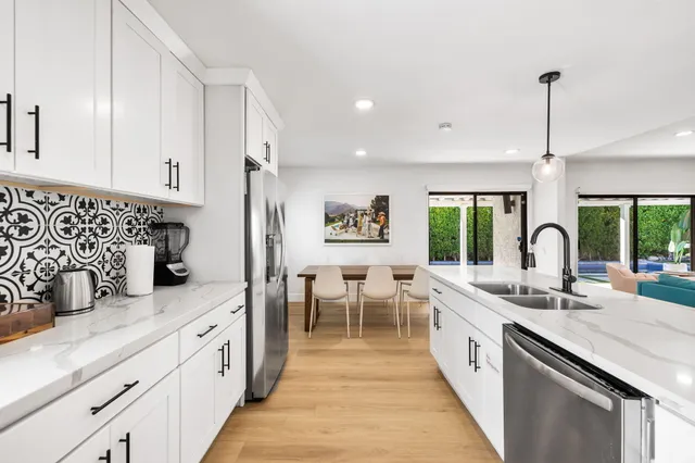 a kitchen with sink attached with living room