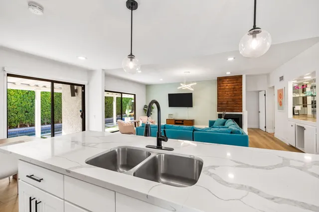a kitchen with cabinets appliances and wooden floor