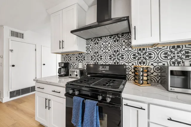 a kitchen with a table chairs refrigerator and cabinets