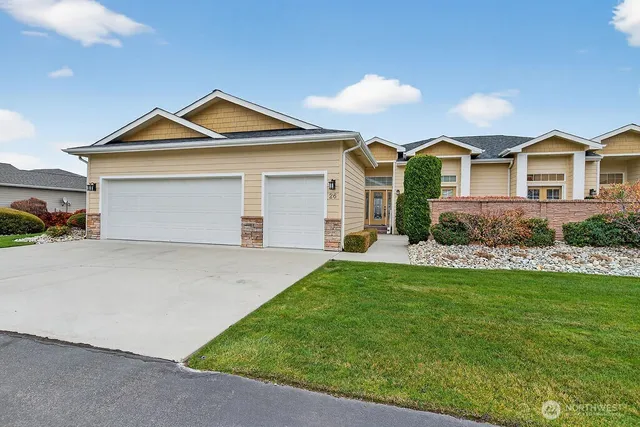 a front view of a house with a yard and garage
