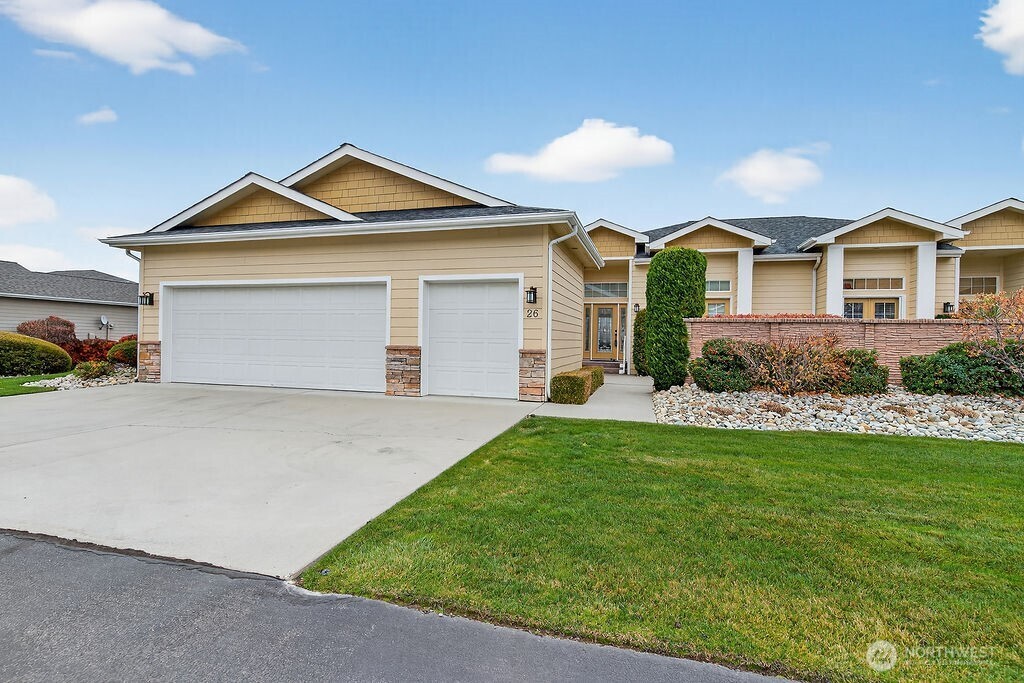 a front view of a house with a yard and garage
