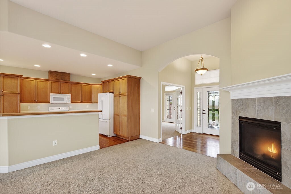 1845 Maple Street, Unit 26 Wenatchee, WA 98801 - Photo 22 of 40 a open kitchen with a refrigerator a oven and a fireplace