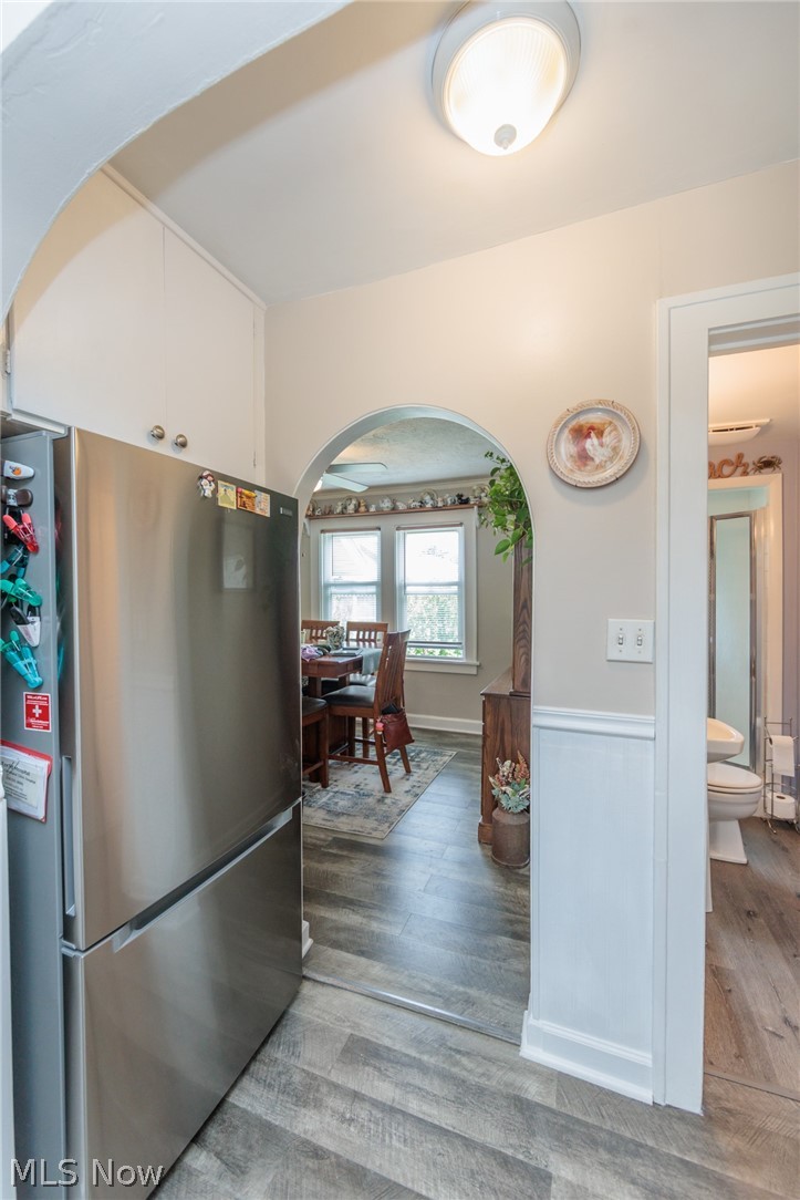5364 Summit Road Lyndhurst, OH 44124 - Photo 31 of 42 Stainless steel refrigerator and wood-finish flooring extending through an arched entryway