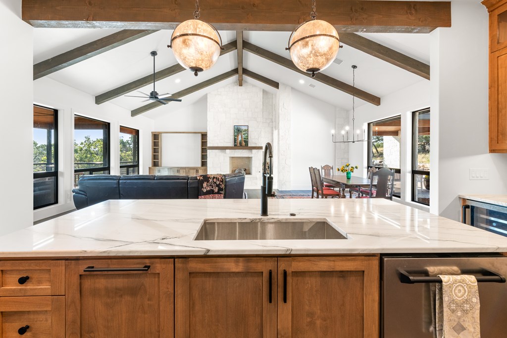 199 Hermosa Road Southwest Hunt, TX 78024 - Photo 14 of 59 a kitchen with a sink and a clock on the wall