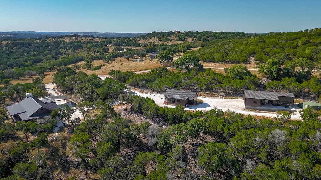 199 Hermosa Road Southwest Hunt, TX 78024 - Photo 2 of 59 an aerial view of residential houses with outdoor space and trees