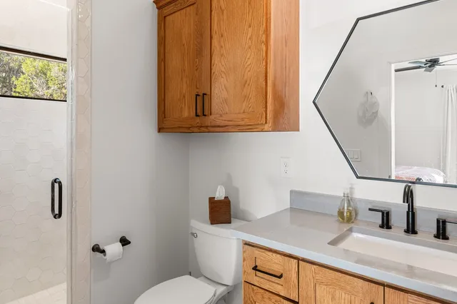 a bathroom with a toilet sink and mirror