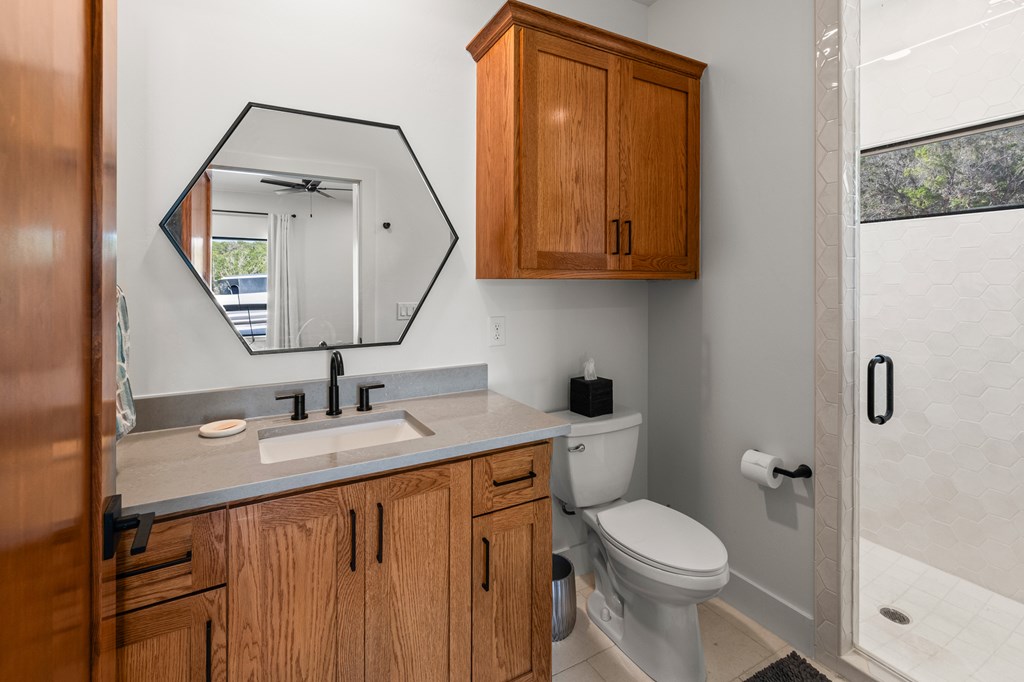 199 Hermosa Road Southwest Hunt, TX 78024 - Photo 31 of 59 a bathroom with a toilet sink and mirror