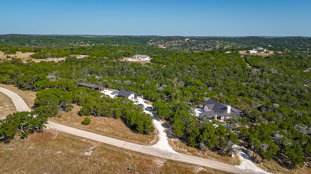 199 Hermosa Road Southwest Hunt, TX 78024 - Photo 41 of 59 an aerial view of residential houses with outdoor space and trees