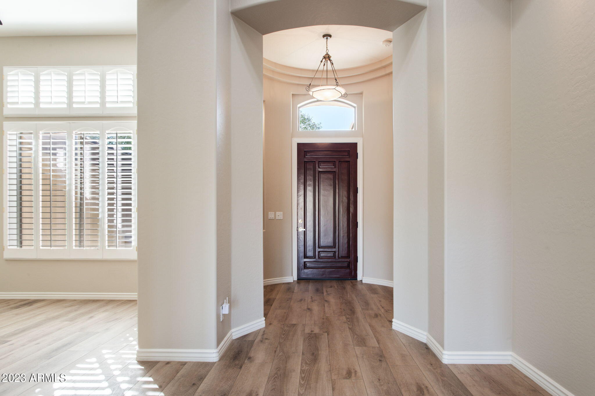 42409 North Back Creek Way Anthem, AZ 85086 - Photo 11 of 87 an empty room with wooden floor and windows