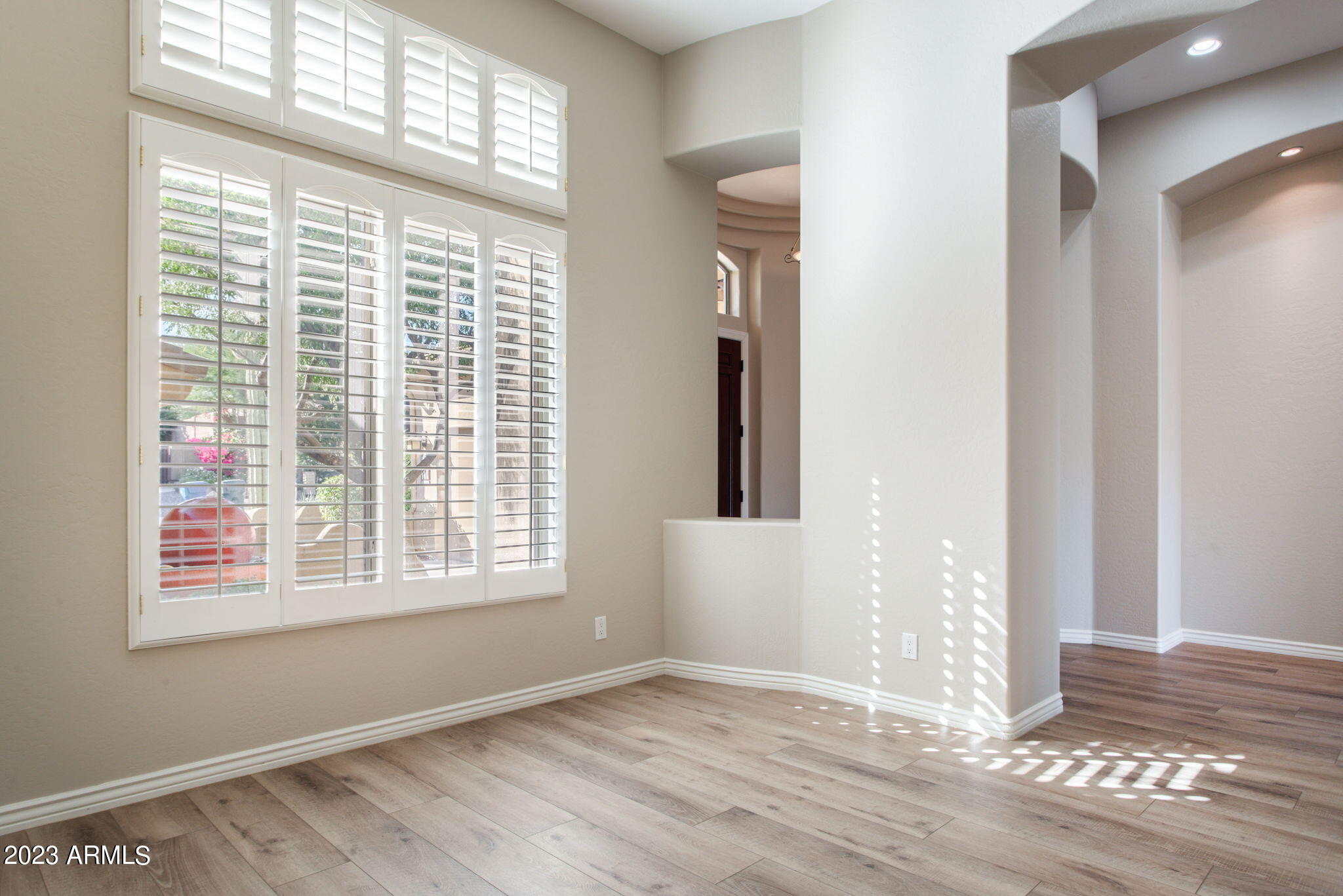 42409 North Back Creek Way Anthem, AZ 85086 - Photo 13 of 87 a view of an empty room with wooden floor and a window