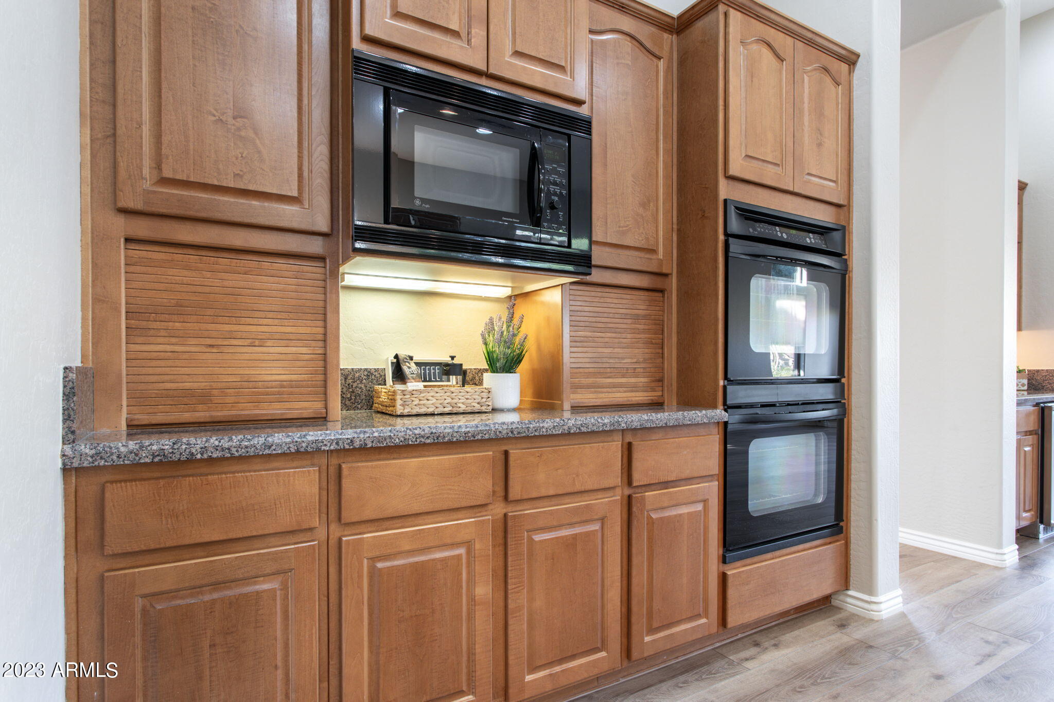 42409 North Back Creek Way Anthem, AZ 85086 - Photo 16 of 87 a kitchen with granite countertop white cabinets and stainless steel appliances