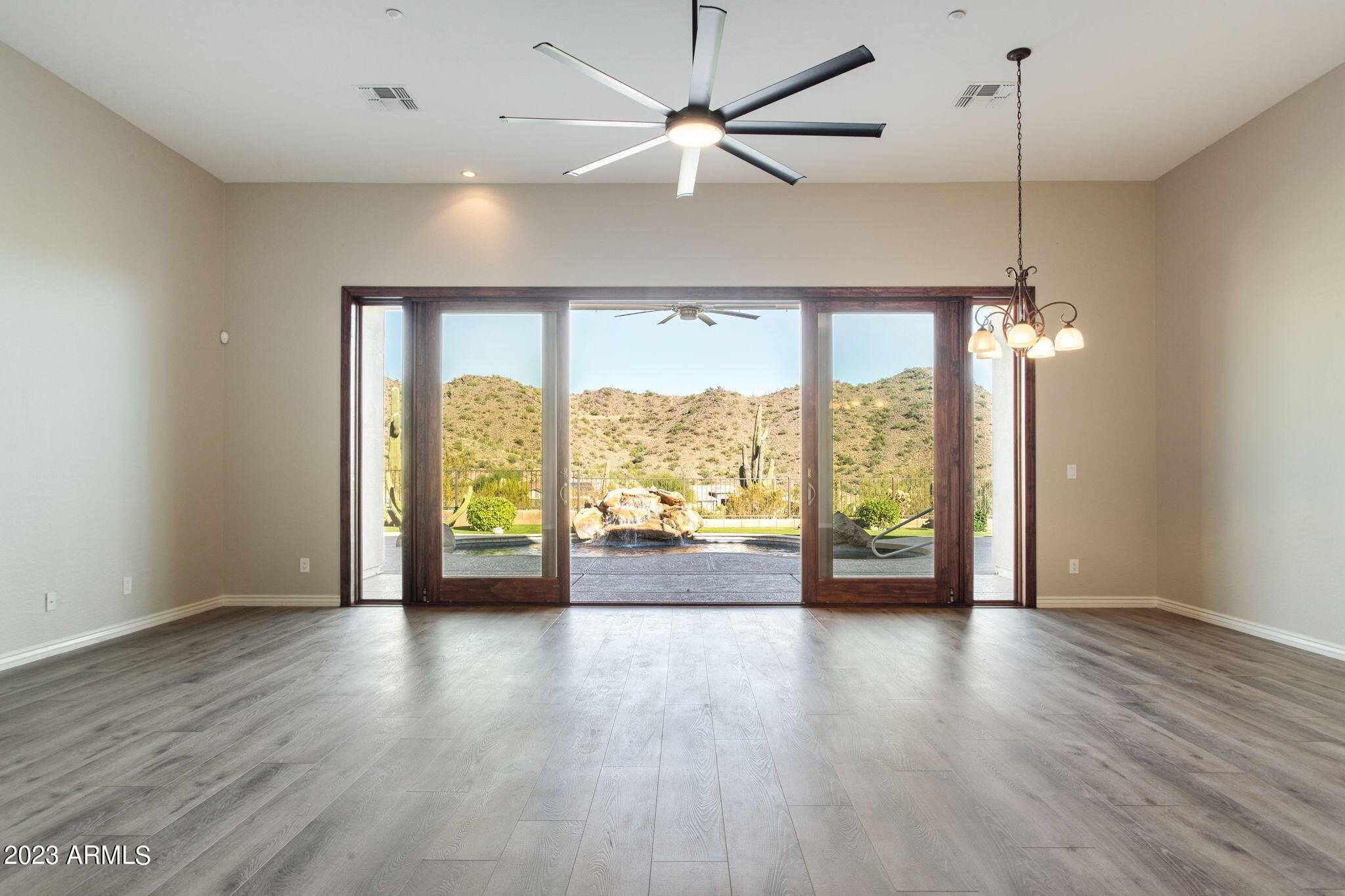 42409 North Back Creek Way Anthem, AZ 85086 - Photo 19 of 87 a view of an empty room with wooden floor and a window