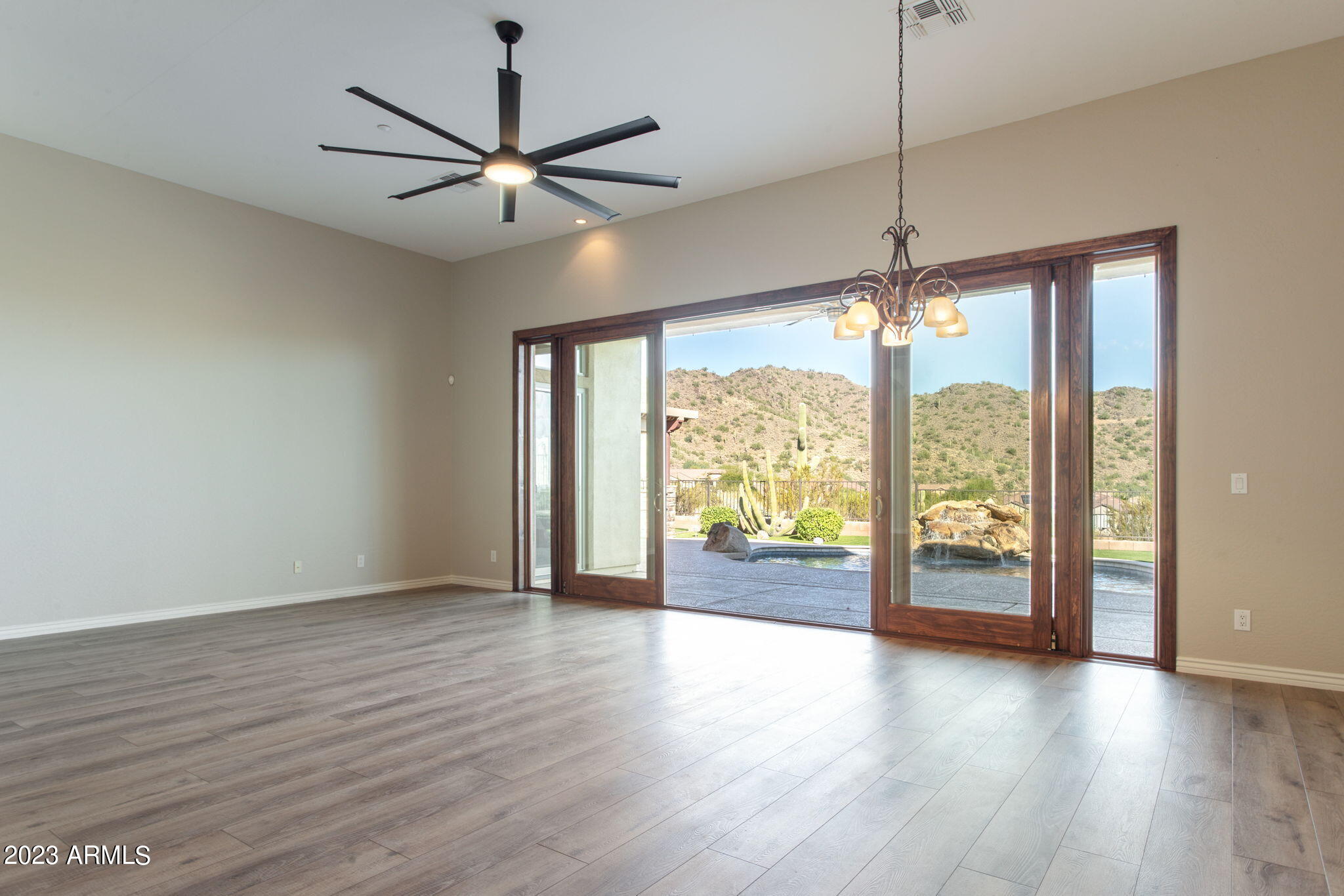 42409 North Back Creek Way Anthem, AZ 85086 - Photo 20 of 87 a view of an empty room with wooden floor and a window