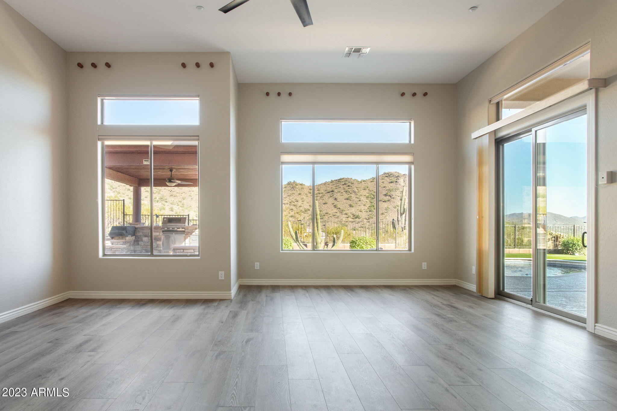 42409 North Back Creek Way Anthem, AZ 85086 - Photo 25 of 87 a view of an empty room with wooden floor and a window