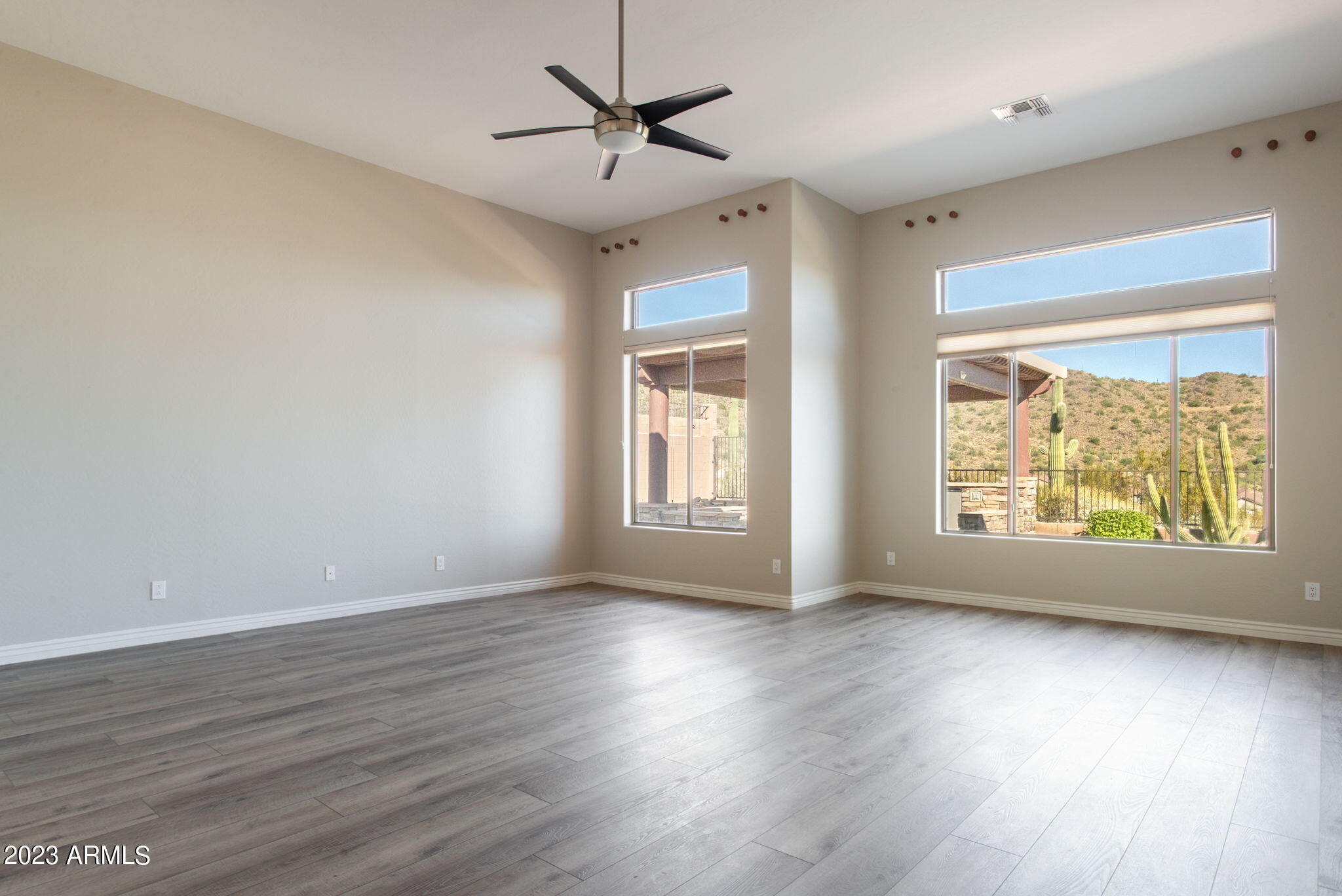 42409 North Back Creek Way Anthem, AZ 85086 - Photo 27 of 87 a view of an empty room with wooden floor and a window
