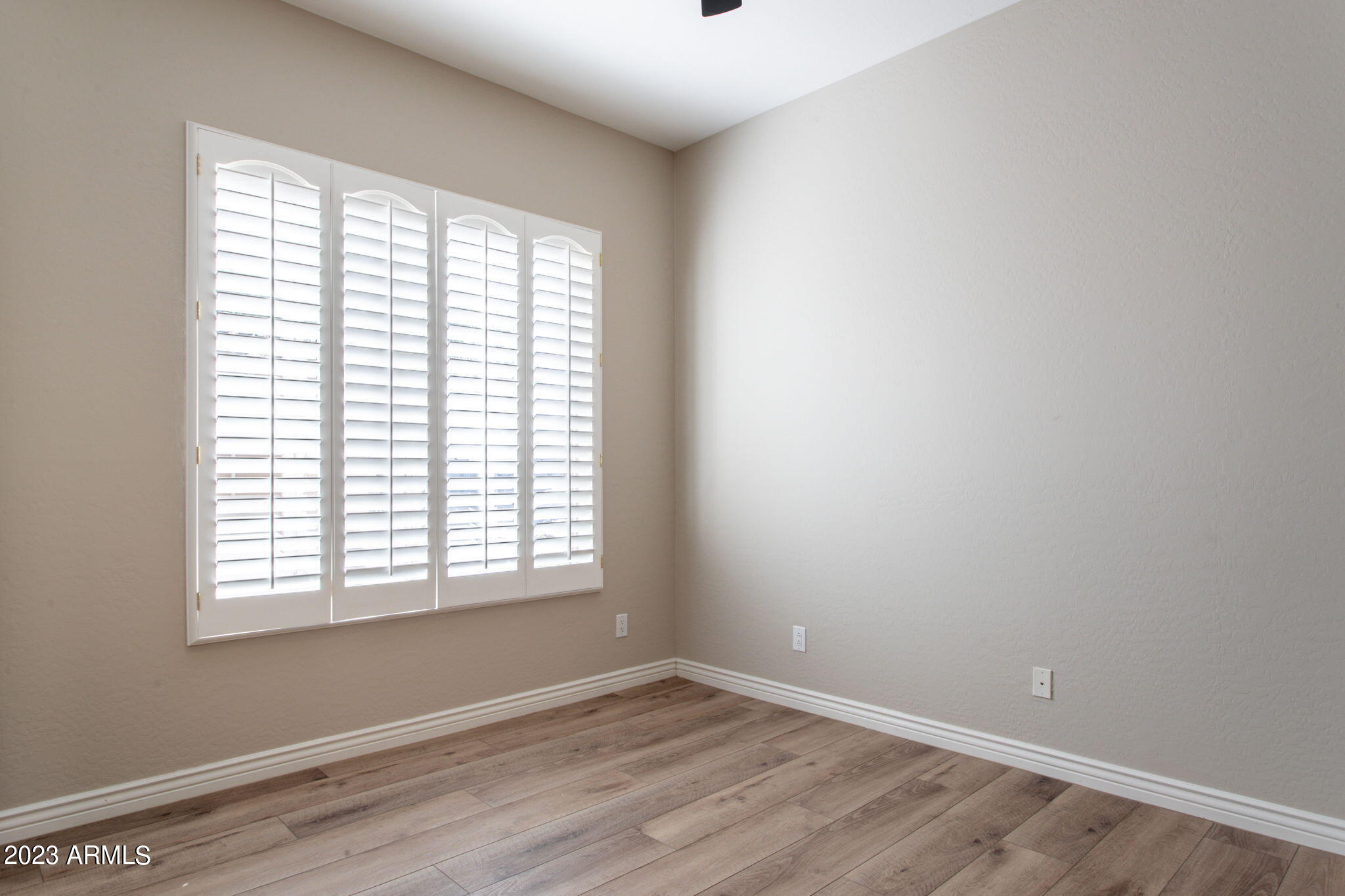 42409 North Back Creek Way Anthem, AZ 85086 - Photo 34 of 87 an empty room with wooden floor and windows