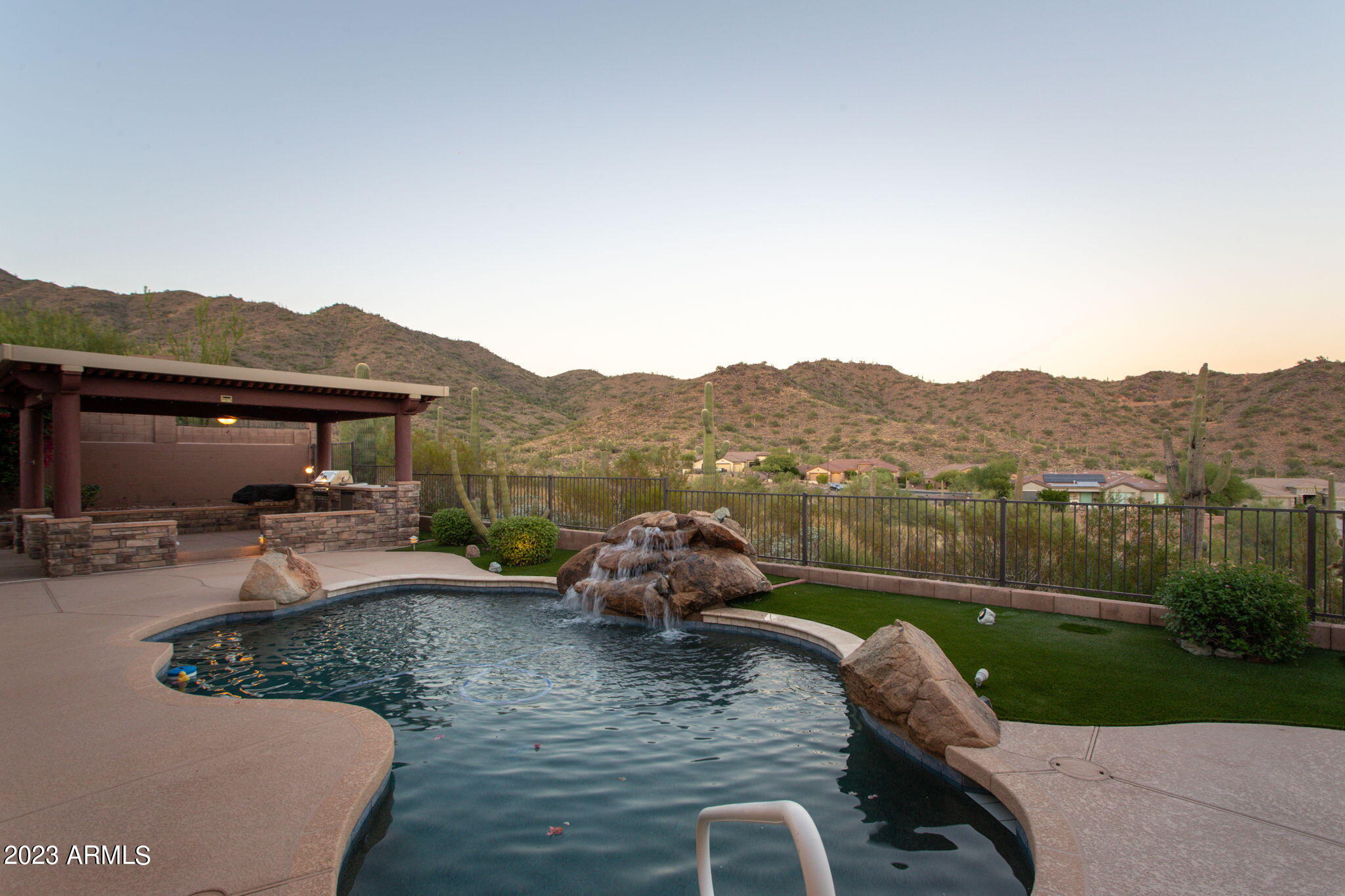 42409 North Back Creek Way Anthem, AZ 85086 - Photo 50 of 87 a view of a lake with a garden and sitting area