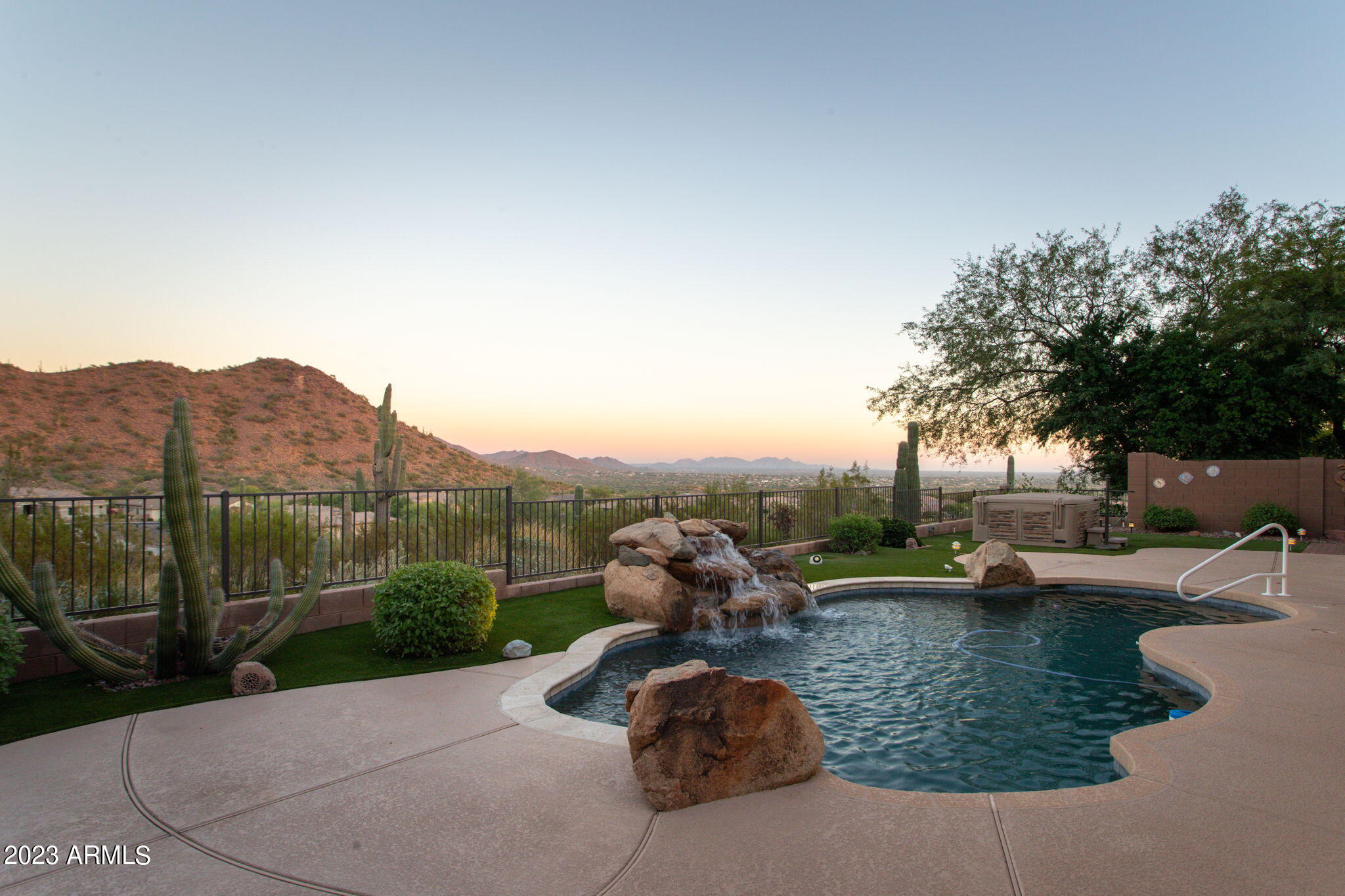 42409 North Back Creek Way Anthem, AZ 85086 - Photo 51 of 87 a view of a lake with a yard and a large window