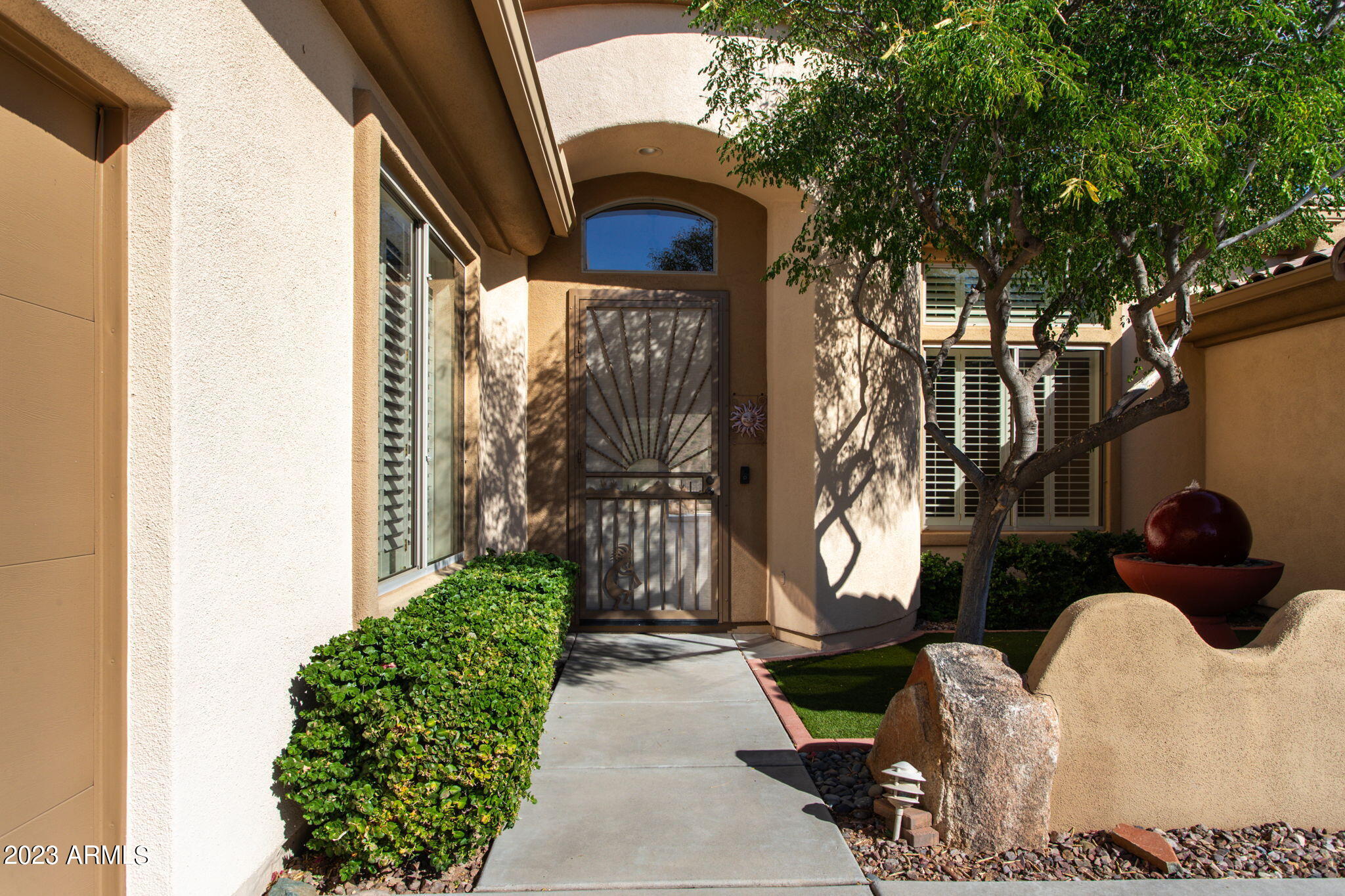 42409 North Back Creek Way Anthem, AZ 85086 - Photo 9 of 87 a view of a porch with a bench next to a yard
