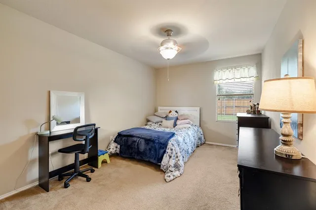 a bedroom with a bed and a table in it