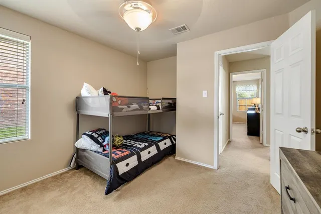 a bedroom with bed and window