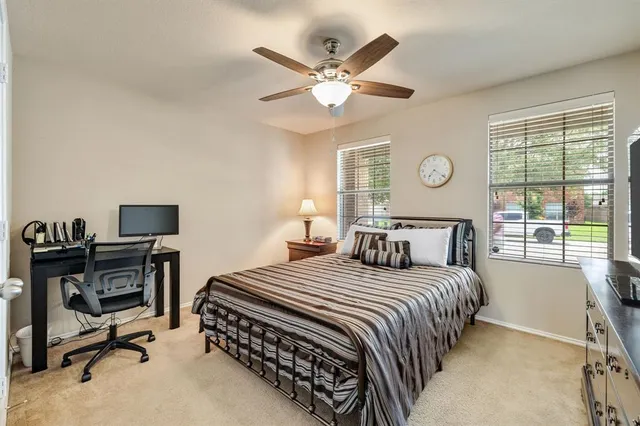 a bedroom with a bed and a large window