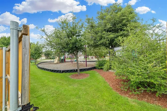 a view of a backyard with garden and entertaining space