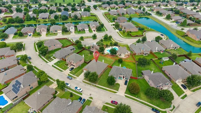 an aerial view of multiple houses with yard