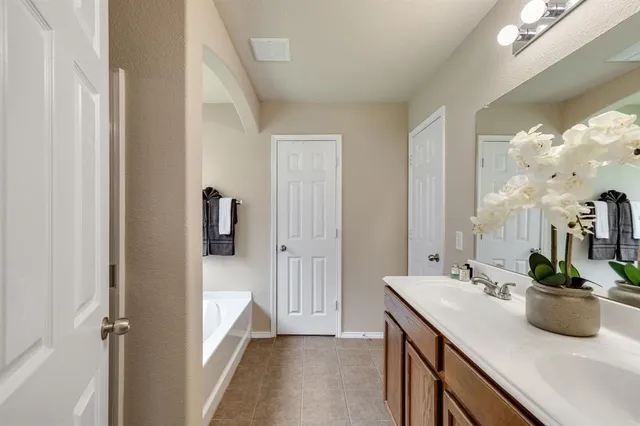 a bathroom with a sink a mirror and a shower