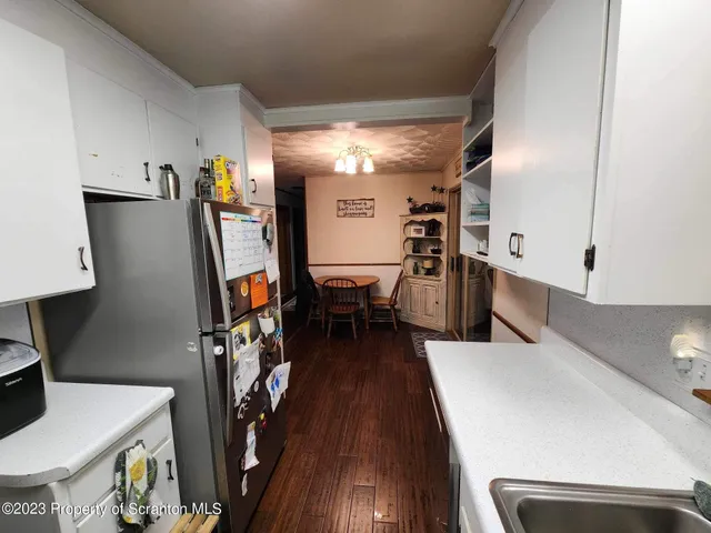 a view of a kitchen with furniture and wooden floor