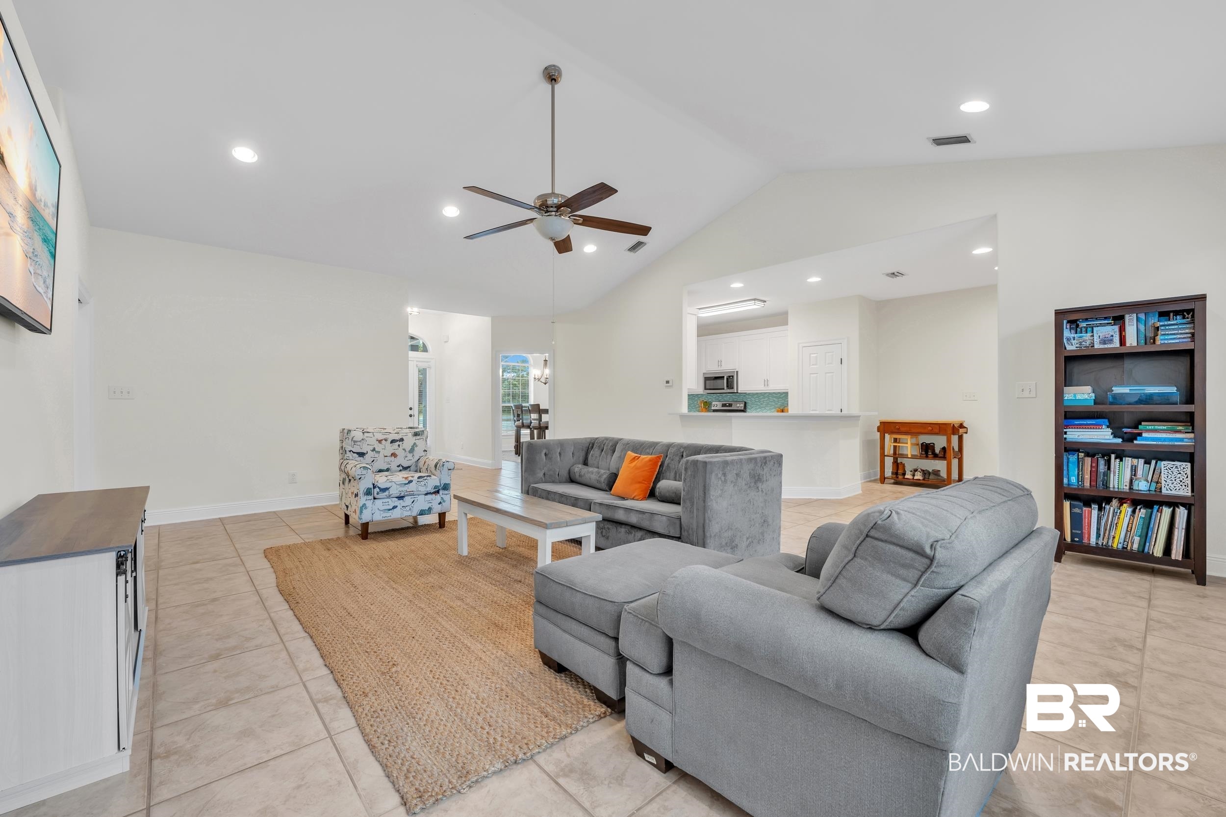 4606 Osprey Drive Orange Beach, AL 36561 - Photo 16 of 44 Living room with a ceiling fan, vaulted ceiling, light tile patterned floors, and recessed lighting