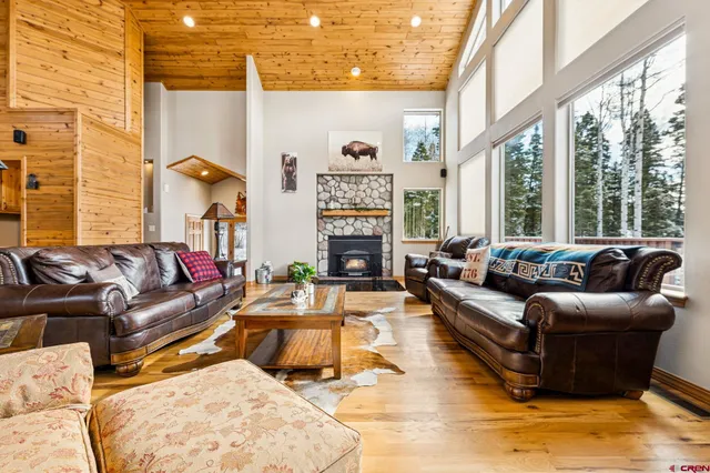 a living room with furniture large window and a fireplace