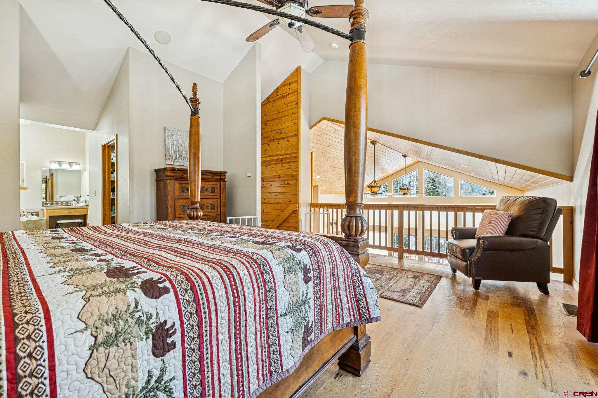 191 Aspen Drive Durango, CO 81301 - Photo 15 of 43 a bedroom with a bed and a large window with wooden floor