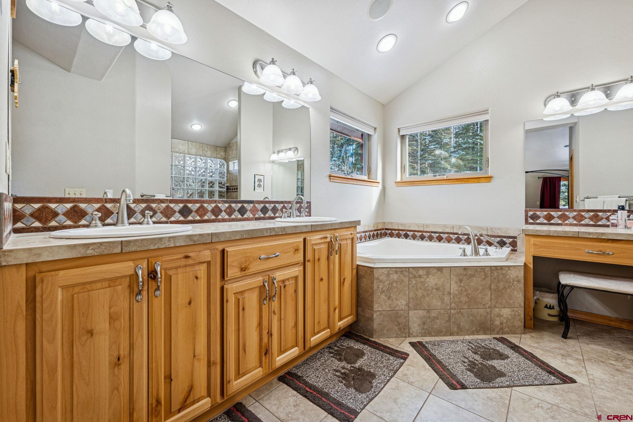 191 Aspen Drive Durango, CO 81301 - Photo 18 of 43 a spacious bathroom with a sink a mirror and a bathtub
